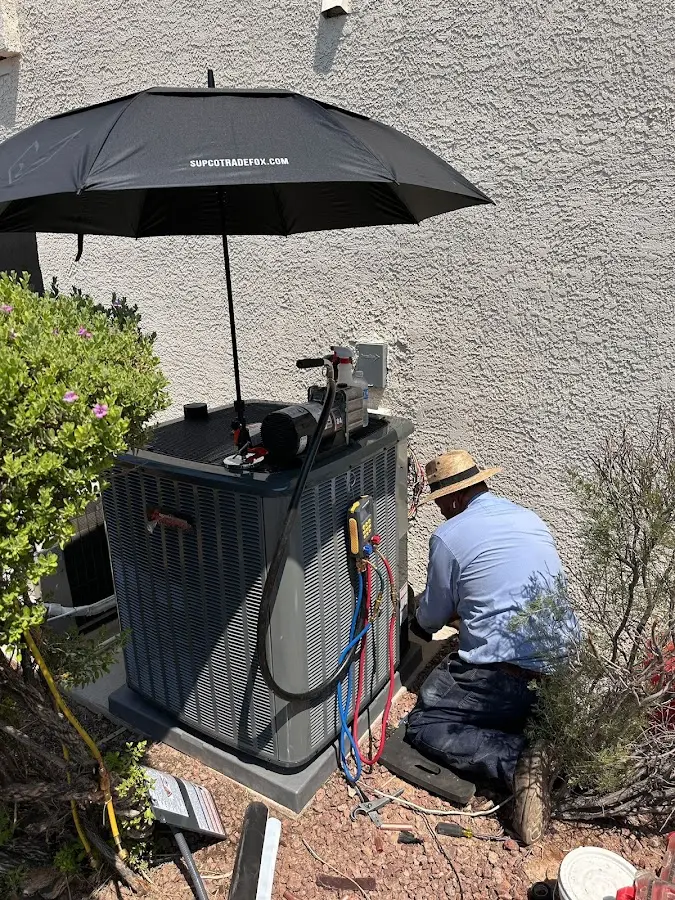 HVAC technician performing outdoor AC maintenance in Little Falls